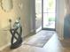 Inviting foyer with a table, decorative mirror, and stylish rug leading to the front door at 2253 Jaybird Dr, Greenfield, IN 46140