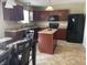Kitchen featuring wooden cabinetry, an island, and modern appliances, all illuminated by pendant lighting at 2253 Jaybird Dr, Greenfield, IN 46140