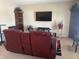 Comfortable living room featuring a large TV and decorative shelves for storage at 2253 Jaybird Dr, Greenfield, IN 46140