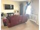 Cozy living room features neutral walls, carpet flooring, and large TV for relaxing evenings at 2253 Jaybird Dr, Greenfield, IN 46140