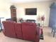 Comfortable living room offers media center with a large TV for entertainment and a view of shelves at 2253 Jaybird Dr, Greenfield, IN 46140