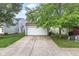 Charming home featuring a two-car garage, neutral siding and mature trees at 2270 Collins Way, Greenfield, IN 46140