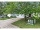 Home featuring neutral siding, two-car garage, driveway and mature trees at 2270 Collins Way, Greenfield, IN 46140