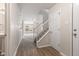 Open foyer featuring laminate flooring, a stairway, and white trim at 2270 Collins Way, Greenfield, IN 46140