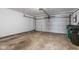 Spacious garage with a concrete floor and white door, providing ample space for parking and storage solutions at 2270 Collins Way, Greenfield, IN 46140