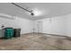Bright garage with concrete floor and a white door, showcasing plenty of room for vehicles and storage needs at 2270 Collins Way, Greenfield, IN 46140