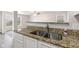 Close-up of the granite countertops and stainless steel sink in a modern kitchen at 2270 Collins Way, Greenfield, IN 46140