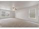 Spacious living room with carpet flooring, ceiling fan, and natural light at 2270 Collins Way, Greenfield, IN 46140
