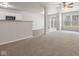 Bright living room with carpeting, a ceiling fan, and natural light from a sliding glass door at 2270 Collins Way, Greenfield, IN 46140