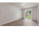 Living room features modern vinyl floors, a sliding glass door, and plenty of natural light at 2270 Collins Way, Greenfield, IN 46140