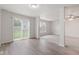 The sun-filled room offers modern vinyl flooring and access to the backyard through sliding glass doors at 2270 Collins Way, Greenfield, IN 46140