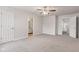 Spacious main bedroom with neutral color palette, a ceiling fan, carpet flooring, and entry to the main bath at 2270 Collins Way, Greenfield, IN 46140