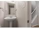 Powder room featuring a pedestal sink, white walls, and a mirror at 2270 Collins Way, Greenfield, IN 46140