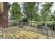 Inviting wooden back deck features chairs and a lounger overlooking a verdant and meticulously maintained lawn at 2553 Forest Hills Blvd, Greenwood, IN 46143