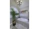 A large soaking tub sits beneath a chandelier and in front of a window at 2553 Forest Hills Blvd, Greenwood, IN 46143