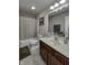 Cozy bathroom featuring dark wood cabinets, large mirror, shower, and tiled flooring at 2553 Forest Hills Blvd, Greenwood, IN 46143