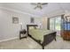 Cozy bedroom featuring a ceiling fan, tray ceilings, bedside table, and carpet at 2553 Forest Hills Blvd, Greenwood, IN 46143