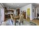 Inviting dining area with wood table, chairs, and hardwood floors, open to the kitchen and featuring access to the deck at 2553 Forest Hills Blvd, Greenwood, IN 46143