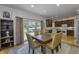 Dining area with wooden table, seating for six, and a view of the backyard through sliding glass doors to the deck at 2553 Forest Hills Blvd, Greenwood, IN 46143