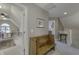 A bench sits in the upstairs hallway near a room for working at 2553 Forest Hills Blvd, Greenwood, IN 46143