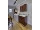 Functional laundry room with wooden cabinets, a utility sink, a washer, and a dryer, all set on hardwood floors at 2553 Forest Hills Blvd, Greenwood, IN 46143
