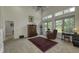 Cozy living room with neutral carpet, complemented by a decorative oriental rug, features an accent chair and ample natural light at 2553 Forest Hills Blvd, Greenwood, IN 46143