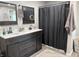 Well-lit bathroom features double sinks, a modern vanity, and neutral color scheme at 260 S 250 W, Greenfield, IN 46140