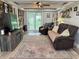 Open living area features rustic wood accent wall, ceiling fan, and sliding glass doors to the backyard at 260 S 250 W, Greenfield, IN 46140