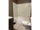 Bathroom with white tiled floors, a tub-shower combo and toilet at 319 S Temple Ave, Indianapolis, IN 46201