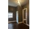 Hallway featuring hard surface floors, white trim, and access to other rooms at 319 S Temple Ave, Indianapolis, IN 46201