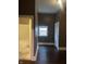Hallway featuring hard surface floors, white trim, and access to the bathroom at 319 S Temple Ave, Indianapolis, IN 46201