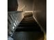Carpeted stairway featuring a railing at 319 S Temple Ave, Indianapolis, IN 46201