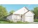 Single story home with a porch, white siding, black trim, and a two car garage at 3226 Keystone Lakes Way, Indianapolis, IN 46237