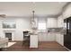 Bright kitchen with white cabinets, modern appliances, and a cozy breakfast bar at 3226 Keystone Lakes Way, Indianapolis, IN 46237