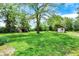 Expansive backyard featuring two sheds and a large tree, offering ample space for outdoor activities and storage at 3317 S 100 E, Greenfield, IN 46140