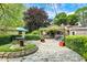 Beautiful backyard featuring a stone patio, water fountain, lush landscaping, and inviting outdoor spaces at 3317 S 100 E, Greenfield, IN 46140