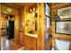 Charming wooden bathroom featuring a single sink vanity and doorway to the kitchen at 3317 S 100 E, Greenfield, IN 46140