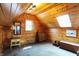 An attic bedroom features wood paneled walls and natural light from windows and skylights at 3317 S 100 E, Greenfield, IN 46140