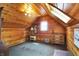 An attic bedroom features wood paneled walls and natural light from windows and skylights at 3317 S 100 E, Greenfield, IN 46140