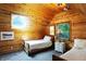 Cozy bedroom featuring wood-paneled walls, a window, twin beds, and a charming bedside table at 3317 S 100 E, Greenfield, IN 46140
