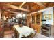 Dining room with wood ceiling, fireplace and view to the kitchen, blending rustic charm with modern convenience at 3317 S 100 E, Greenfield, IN 46140