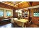 Cozy dining room with wood-paneled walls, a charming window bench, and elegant vintage furniture at 3317 S 100 E, Greenfield, IN 46140