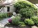 Charming stone home with a landscaped walkway and beautiful flower beds at 3317 S 100 E, Greenfield, IN 46140
