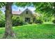 Charming stone house nestled among mature trees and lush green lawn at 3317 S 100 E, Greenfield, IN 46140
