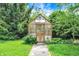 Charming greenhouse nestled in a lush garden, offering a tranquil space for cultivating plants and flowers at 3317 S 100 E, Greenfield, IN 46140