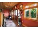 Rustic hallway with wooden walls, a totem pole and door leading to outdoors at 3317 S 100 E, Greenfield, IN 46140