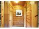 A hallway with all wood construction has a door to the outside and a large framed photograph on the far wall at 3317 S 100 E, Greenfield, IN 46140