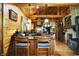 Rustic kitchen with stone accents, wood-burning stove, and island with seating, perfect for gathering and entertaining at 3317 S 100 E, Greenfield, IN 46140