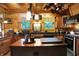 Charming kitchen showcasing wood cabinets, black countertops, and unique decor including hanging copper pots at 3317 S 100 E, Greenfield, IN 46140