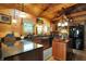 Well-lit rustic kitchen with granite countertops, stainless steel appliances, and wood cabinetry for a cozy feel at 3317 S 100 E, Greenfield, IN 46140